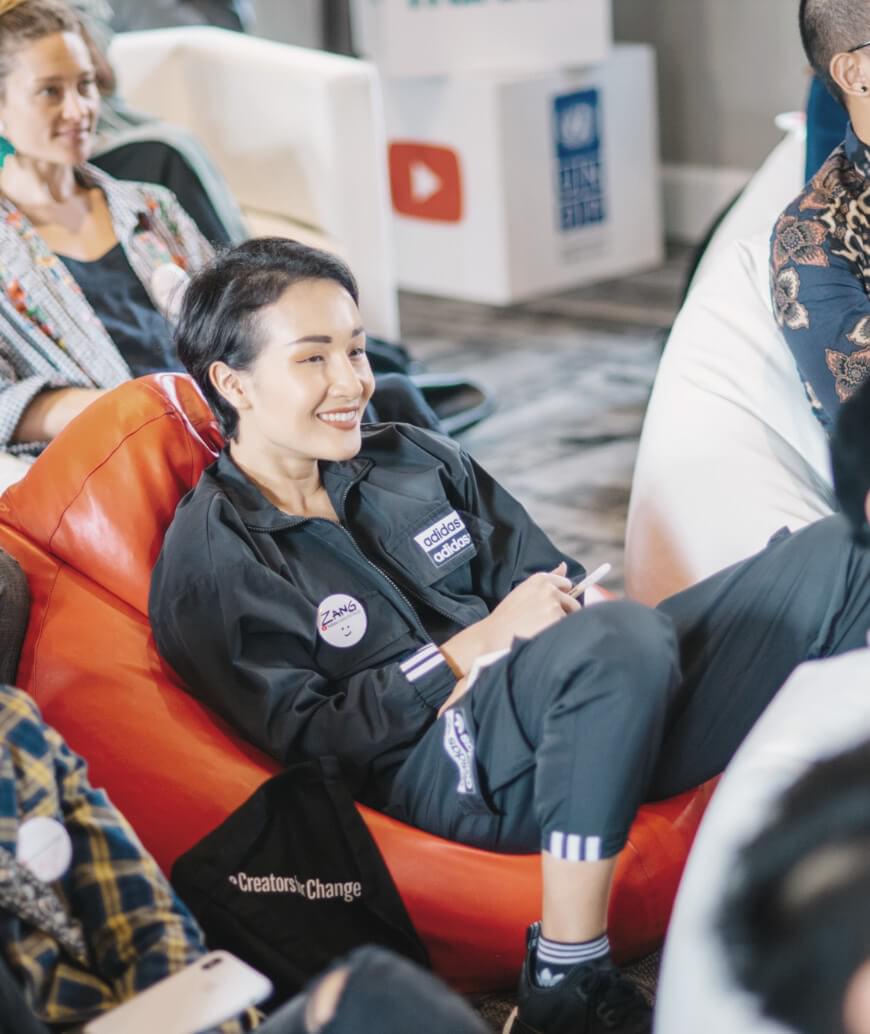 Woman smiling while participating in a conference.