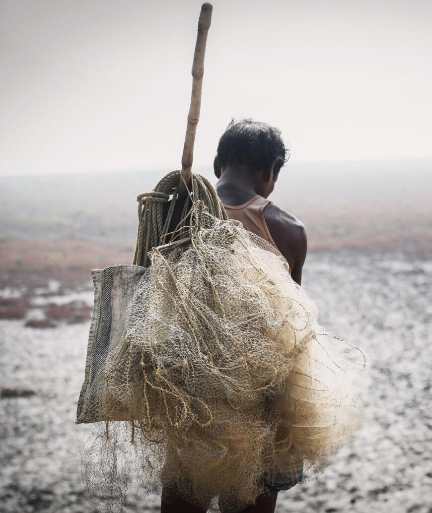 Hard working man holding his fishing gear