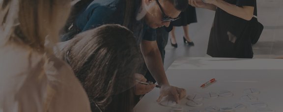 Young group of adults working together in a bootcamp